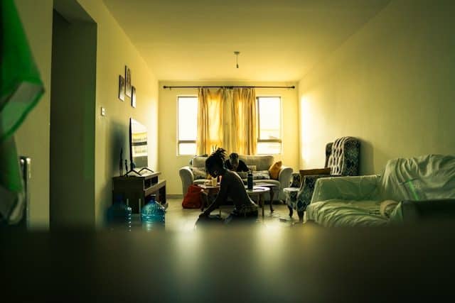 Trip sitter watching over a friend during a psilocybin experience indoors